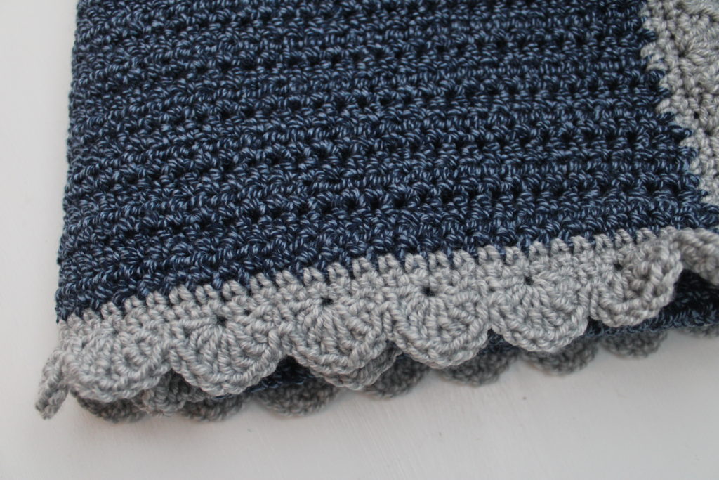 navy afghan with silver scalloped edge closeup