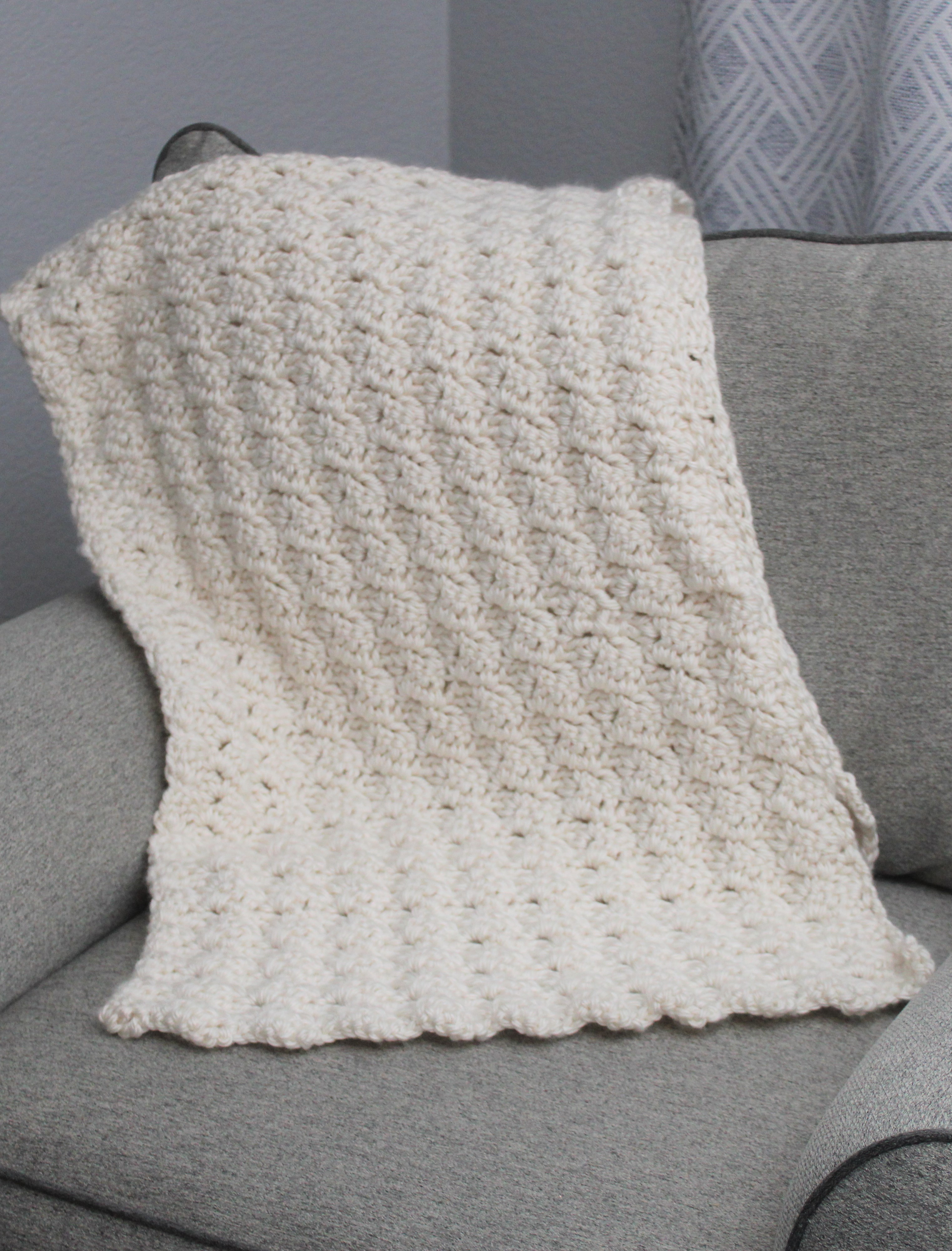 crocheted ivory shawl draped over a chair
