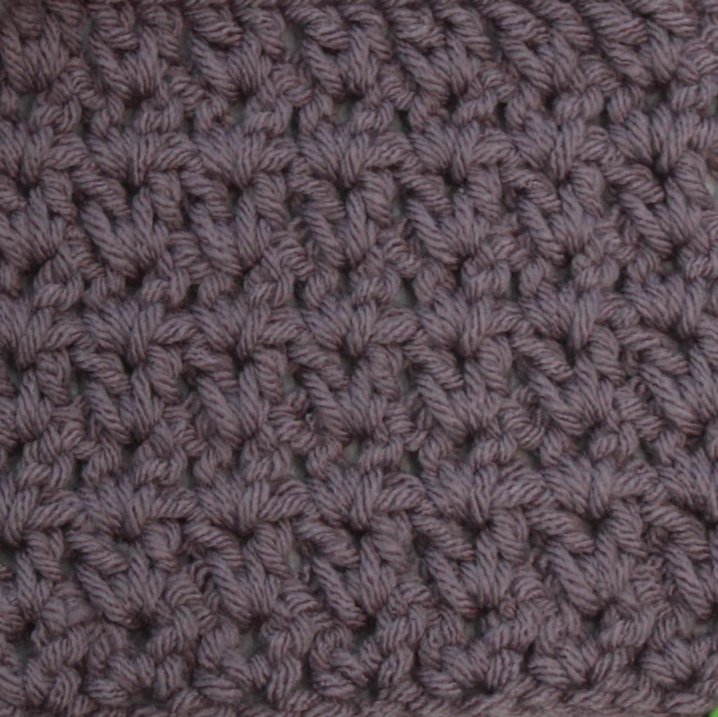 purple crochet swatch showing the no space dc v-stitch