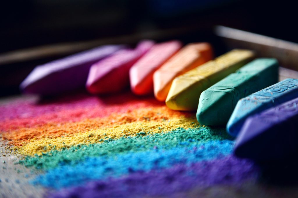 colors of chalk lined up in an arch like a rainbow