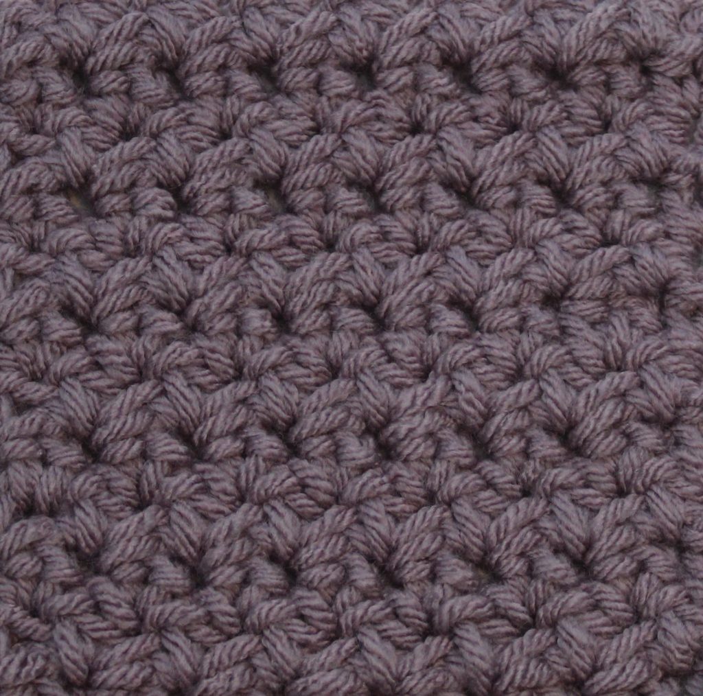 purple crochet swatch showing the woven stitch