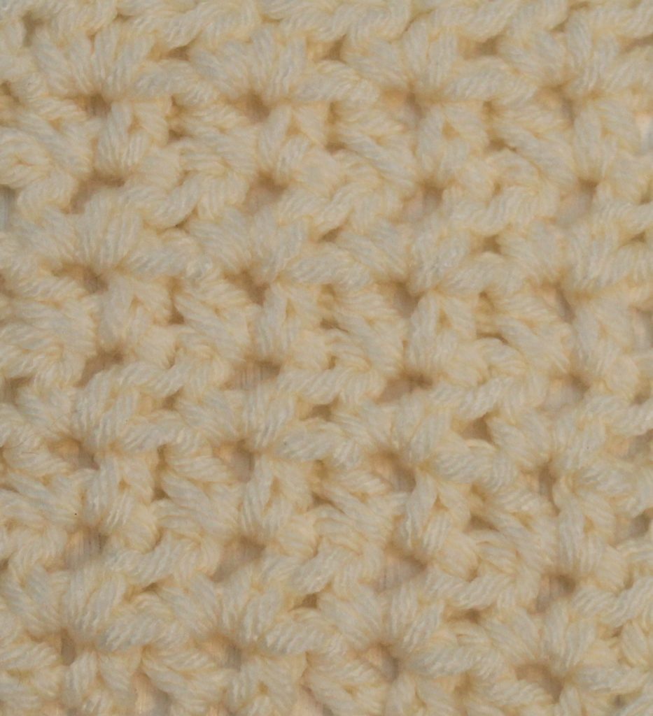 ivory crocheted swatch of the half double crochet v-stitch with a chain 1