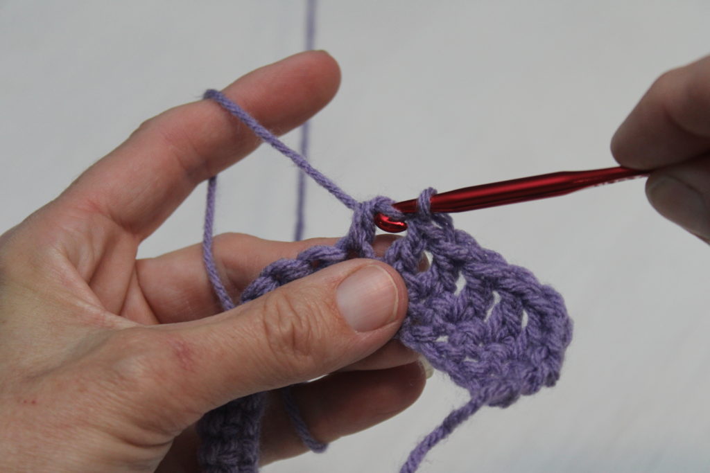 double crochet pulling through first tow loops on hook