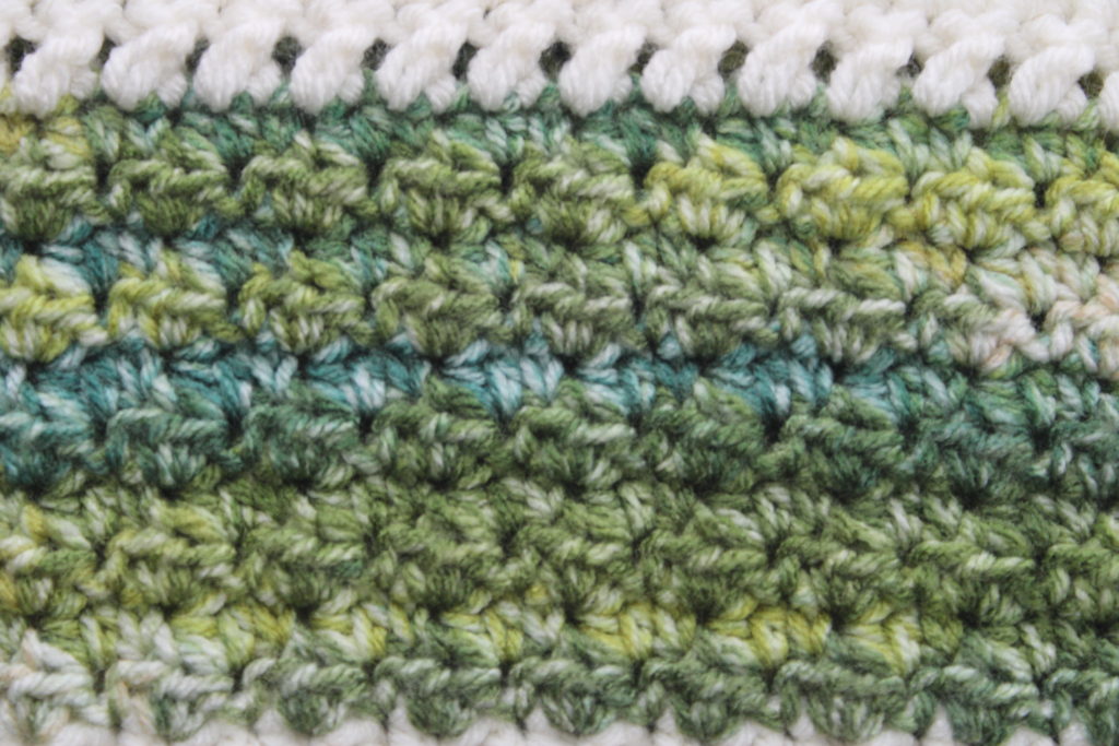 up close view of the tiny cloud stitch in greenn wintergreen crochet throw