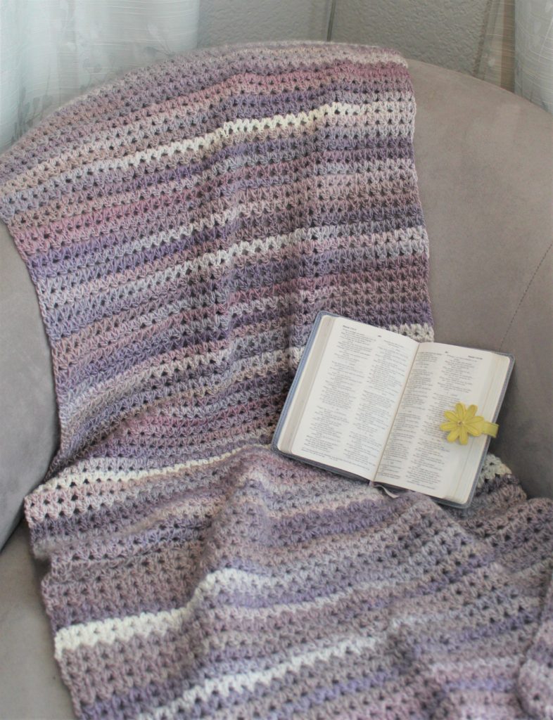 Pearly Gray shawl in grey and purple shawl draped over chair with open bible