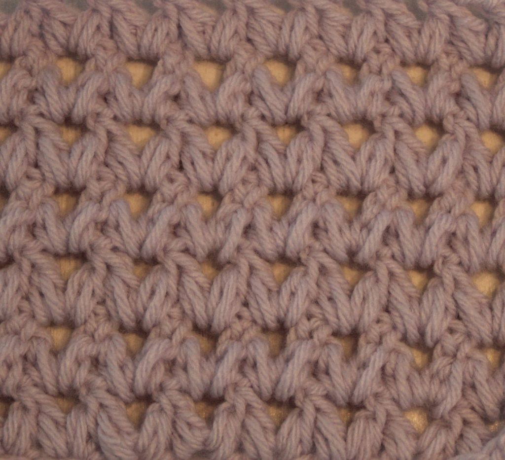 light purple crocheted swatch of the forked cluster stitch