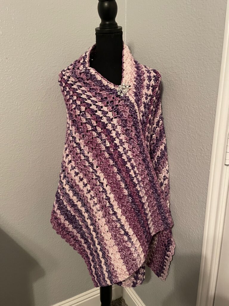 Love's Embrace purple shawl draped over a maniquin