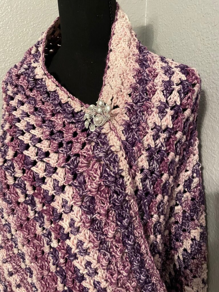 Up close of Love,s Embrace purple shawl draped over a mannequin