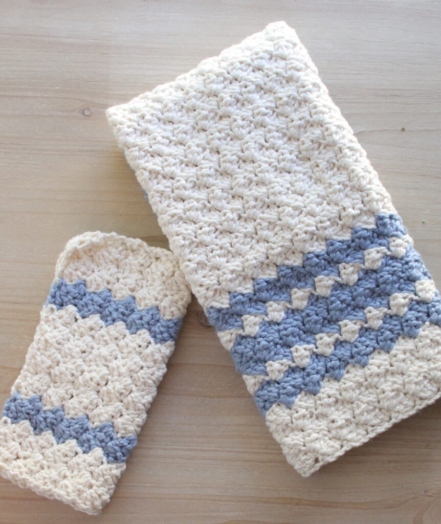 sedge stitch farmhouse tea towel in blue and white crochet towel and dish clothe laid on the table