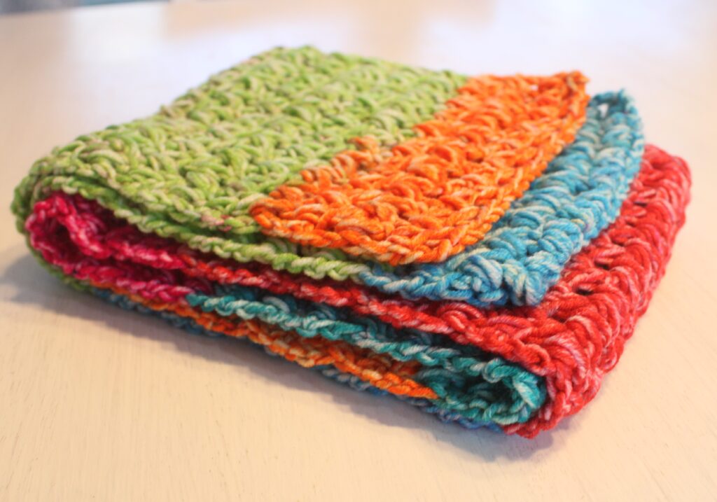 The happy scarf in a forked cluster stitch is bright colored scarf folded and up close