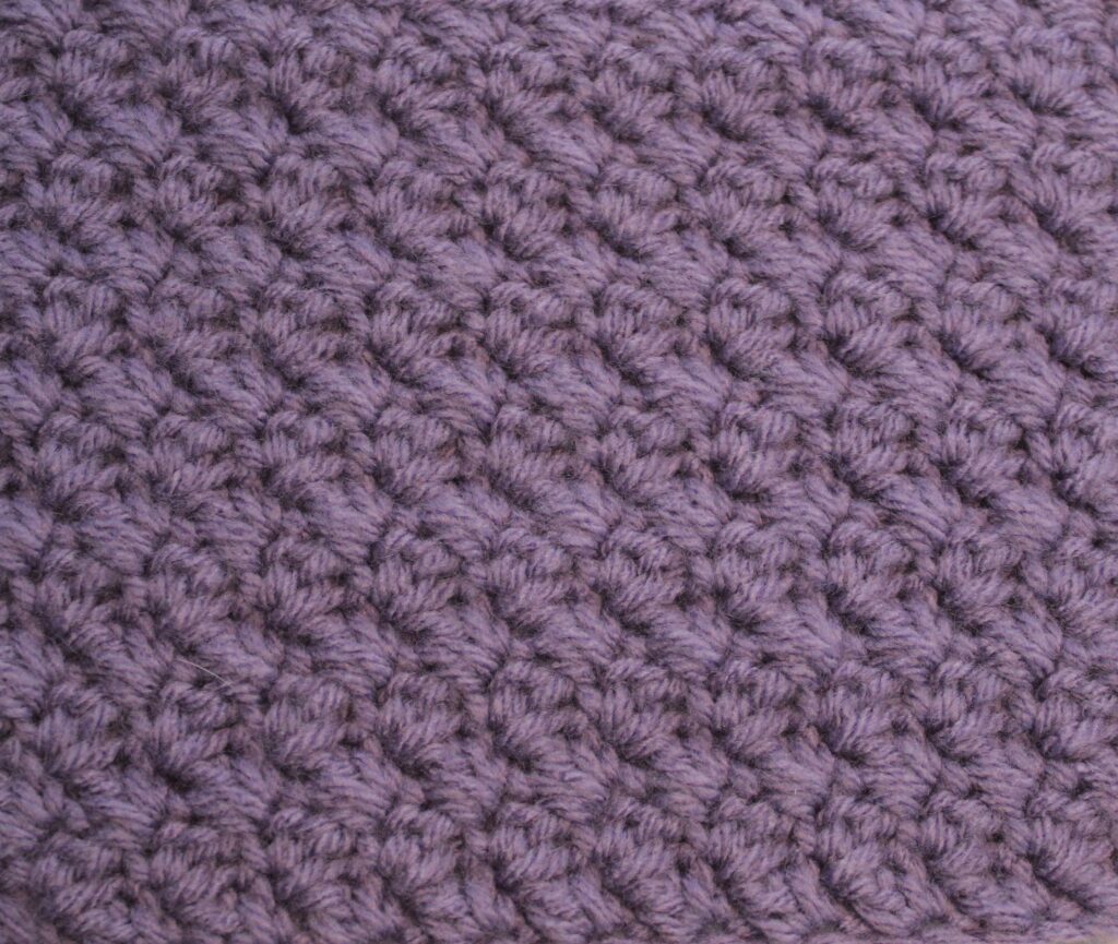 crocheted swatch in purple of the suzette stitch close up
