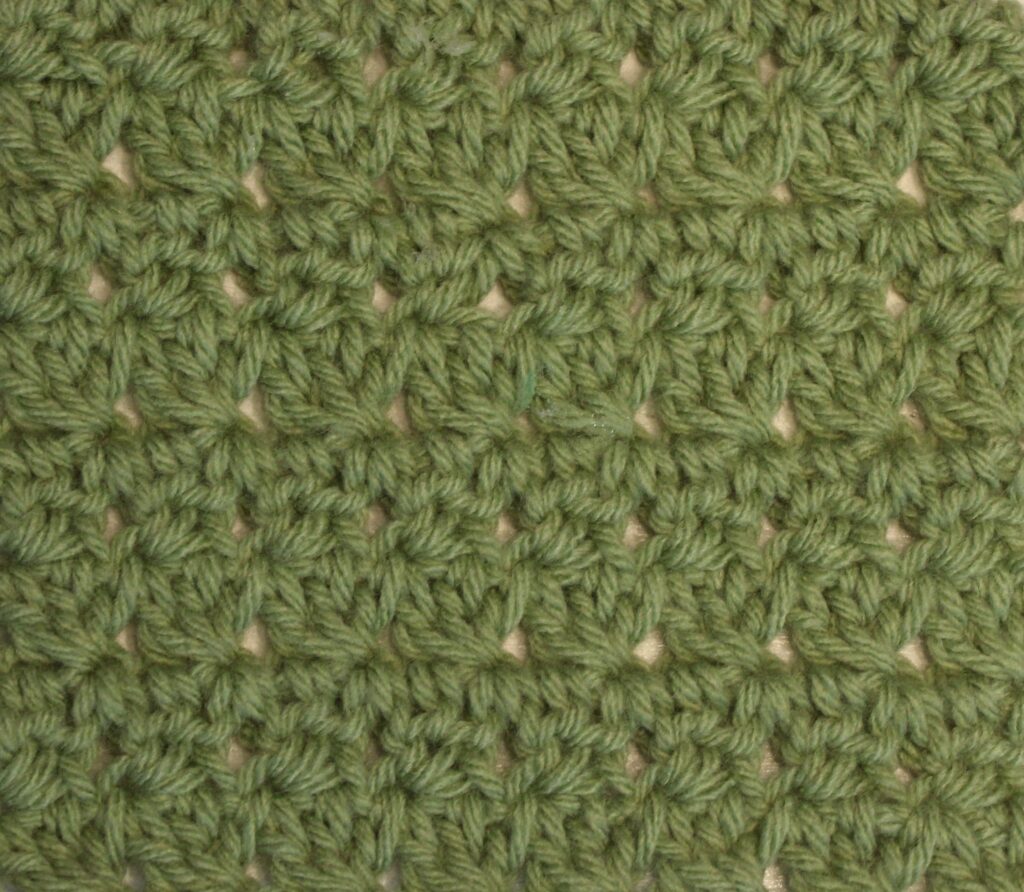 green crocheted swatch of the modified trinity stitch